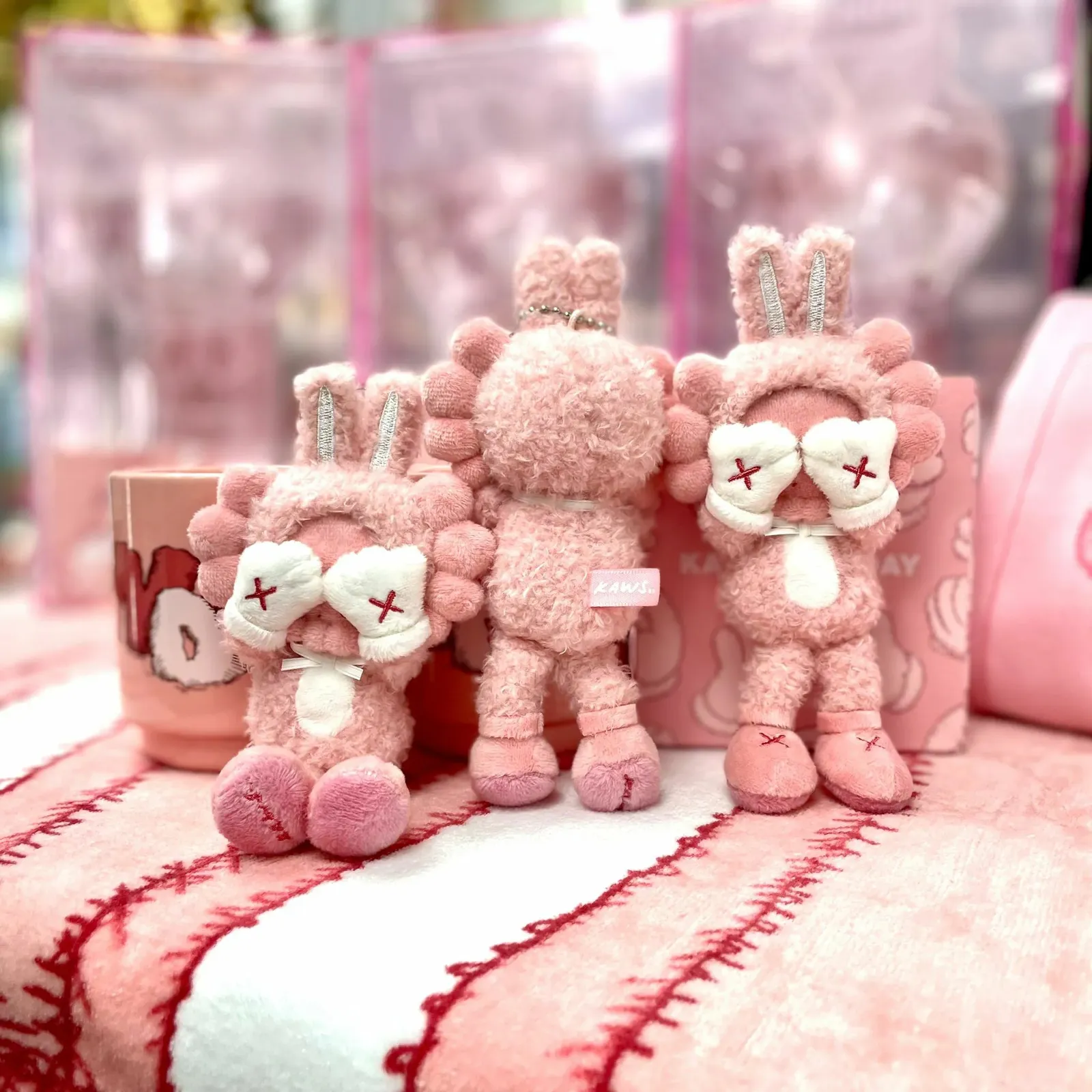 KAWS:HOLIDAY INDONESIA plush keychain, depicting the silhouette of a KAWS character with X-shaped eyes.