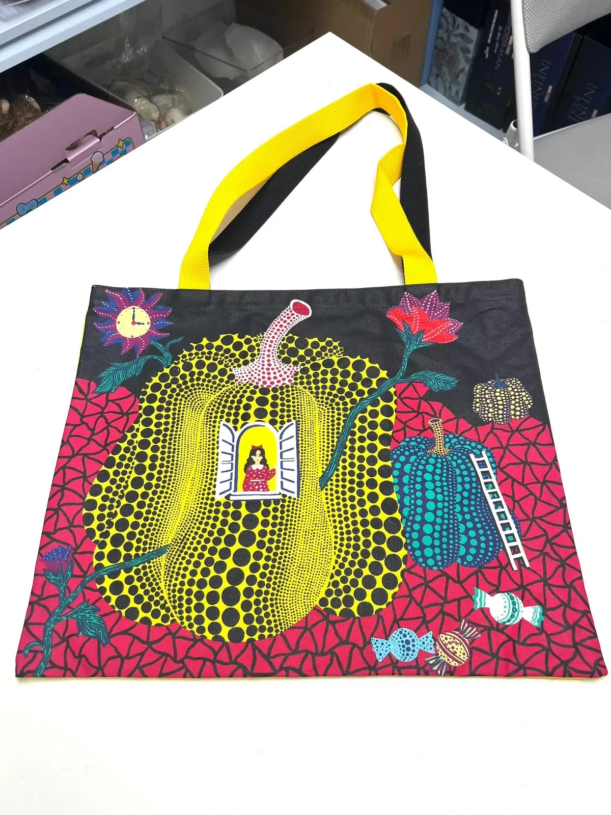Bolso tote blanco YAYOI KUSAMA « Hello » con un gran punto rojo central rodeado de puntos más pequeños, y la palabra « Hello